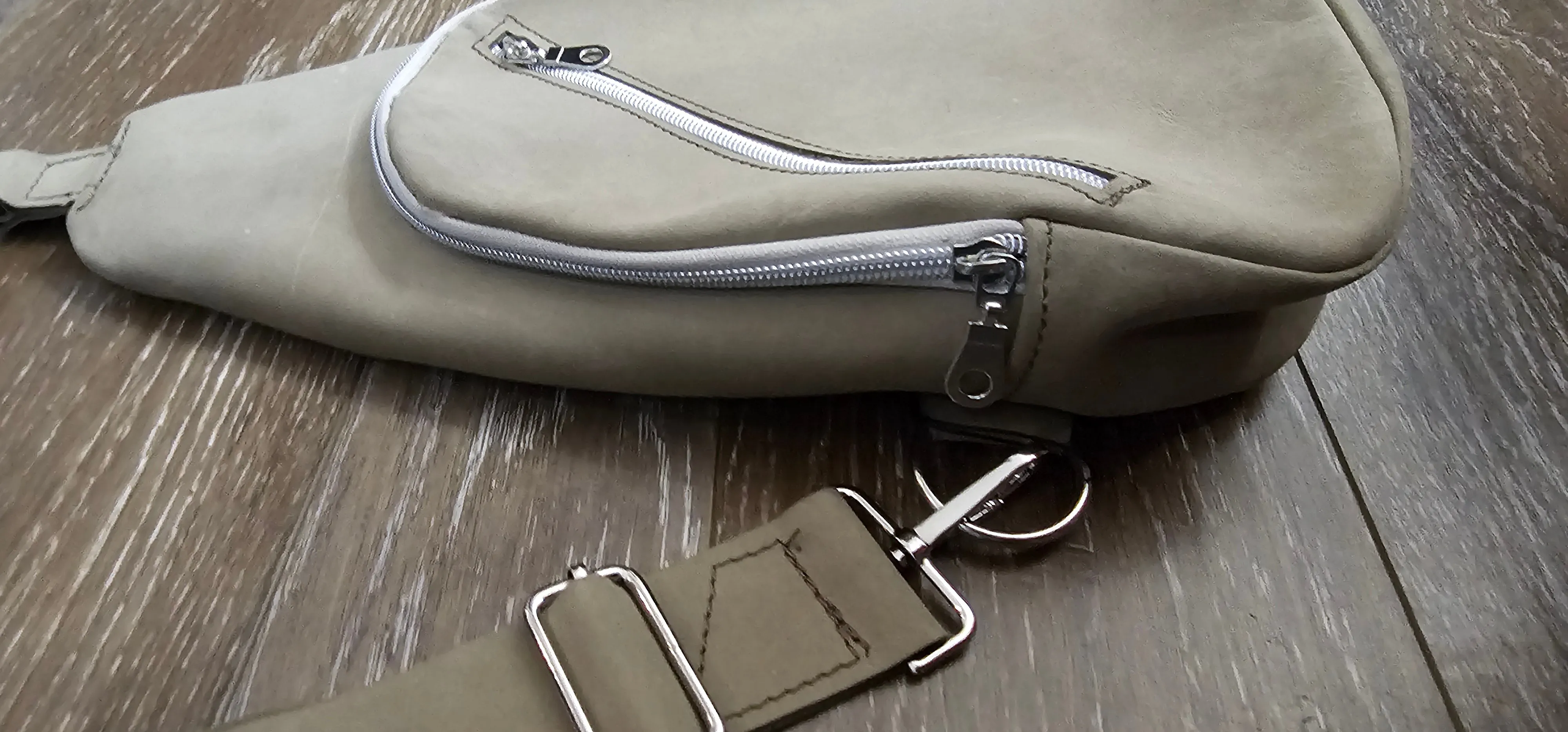 ** sale ** leather sling Moss colored.            slanted front zipper